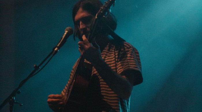 Artist Mountain Boy on stage with a guitar